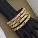Elegant Pearl Beaded Gold Toned Bangle Set with Kundan Stones