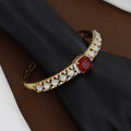 Gold Polished Regal Crimson Solitaire & White Stone Designer Bangle