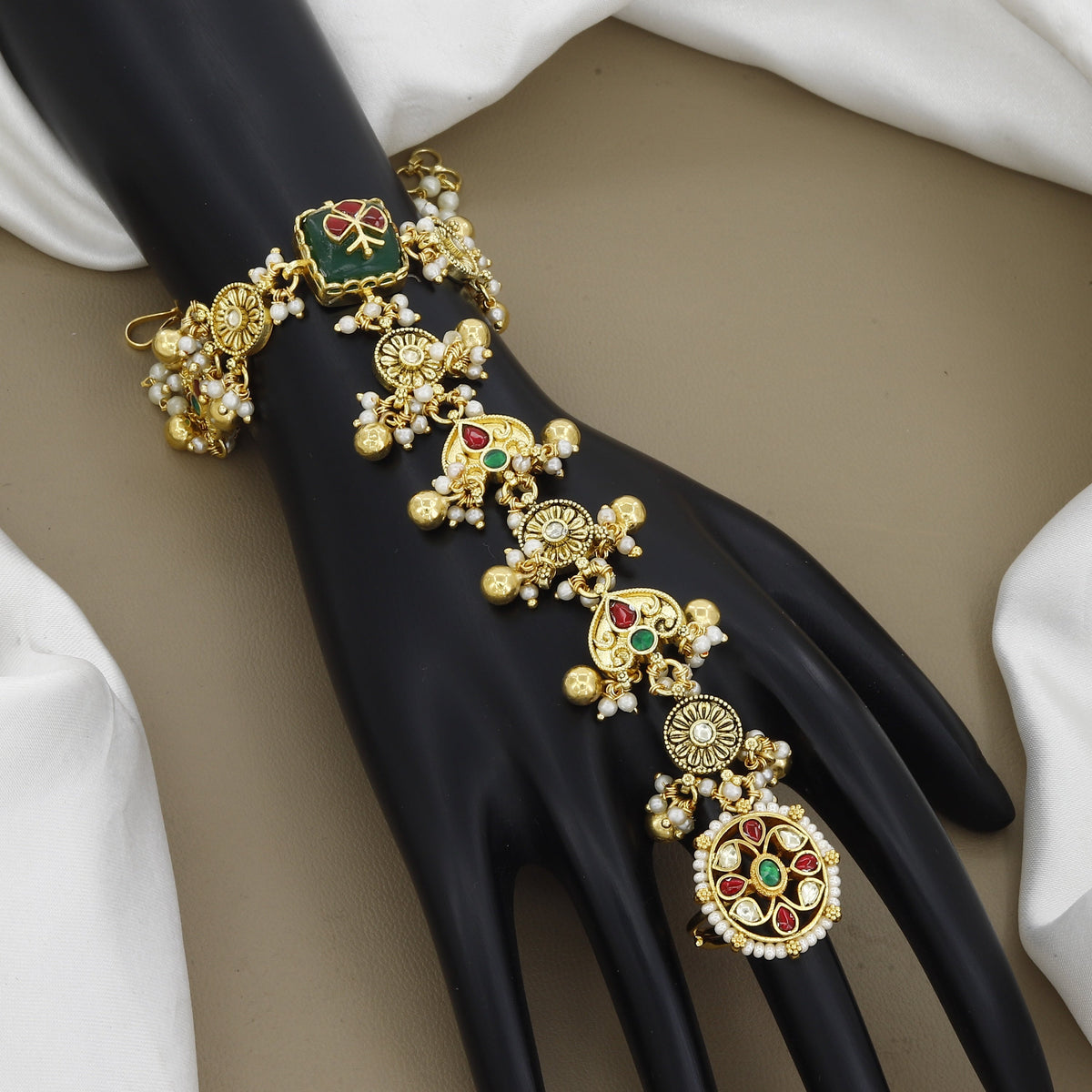 Ethnic Gold-Toned Haathphool with Green Stone & Pearl Charms