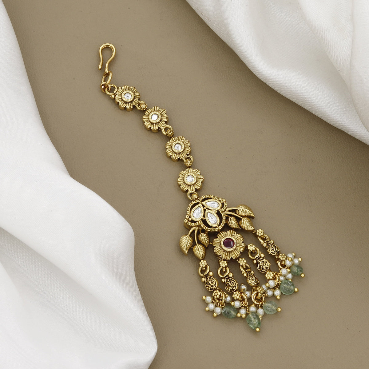 Floral Gold-Plated Maang Tikka with Kundan Accents and Green Beads